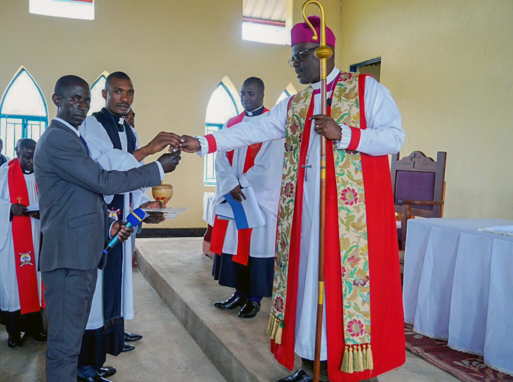 The Bishop handing over the church keys to the Pastor and head of laity